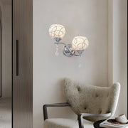 contemporary 2 light wall sconce in open sphere design with crystal pendants