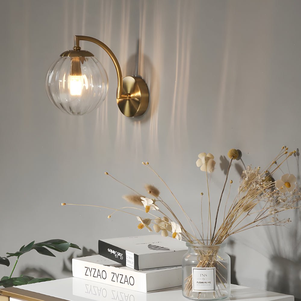 curved arm wall sconce with a single light and ball rib glass shade