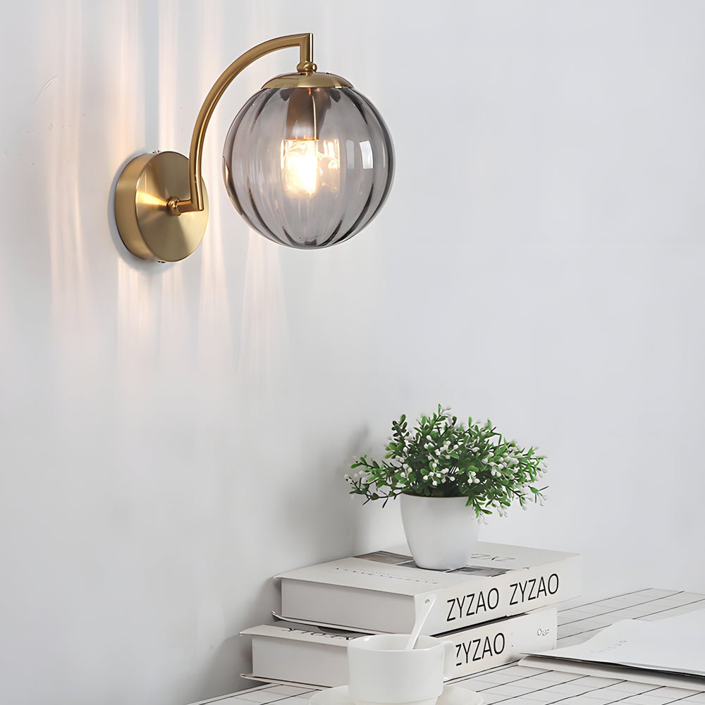 curved arm wall sconce with a single light and ball rib glass shade