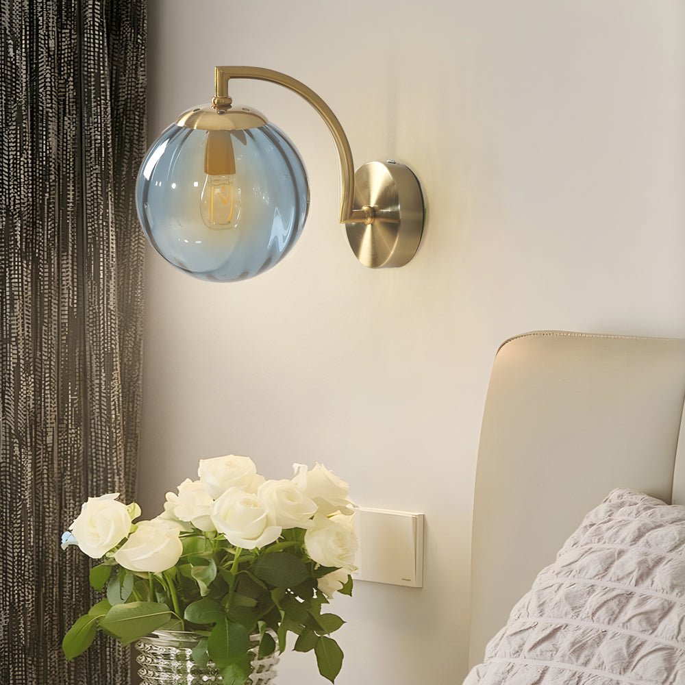 curved arm wall sconce with a single light and ball rib glass shade