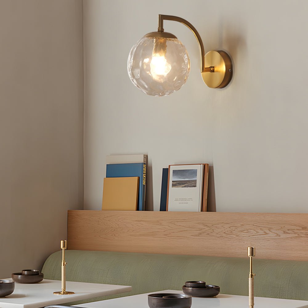 curved arm wall sconce with a single light and ball rib glass shade