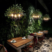 iron cage pendant light inspired by the enchanted forest adorned with vines