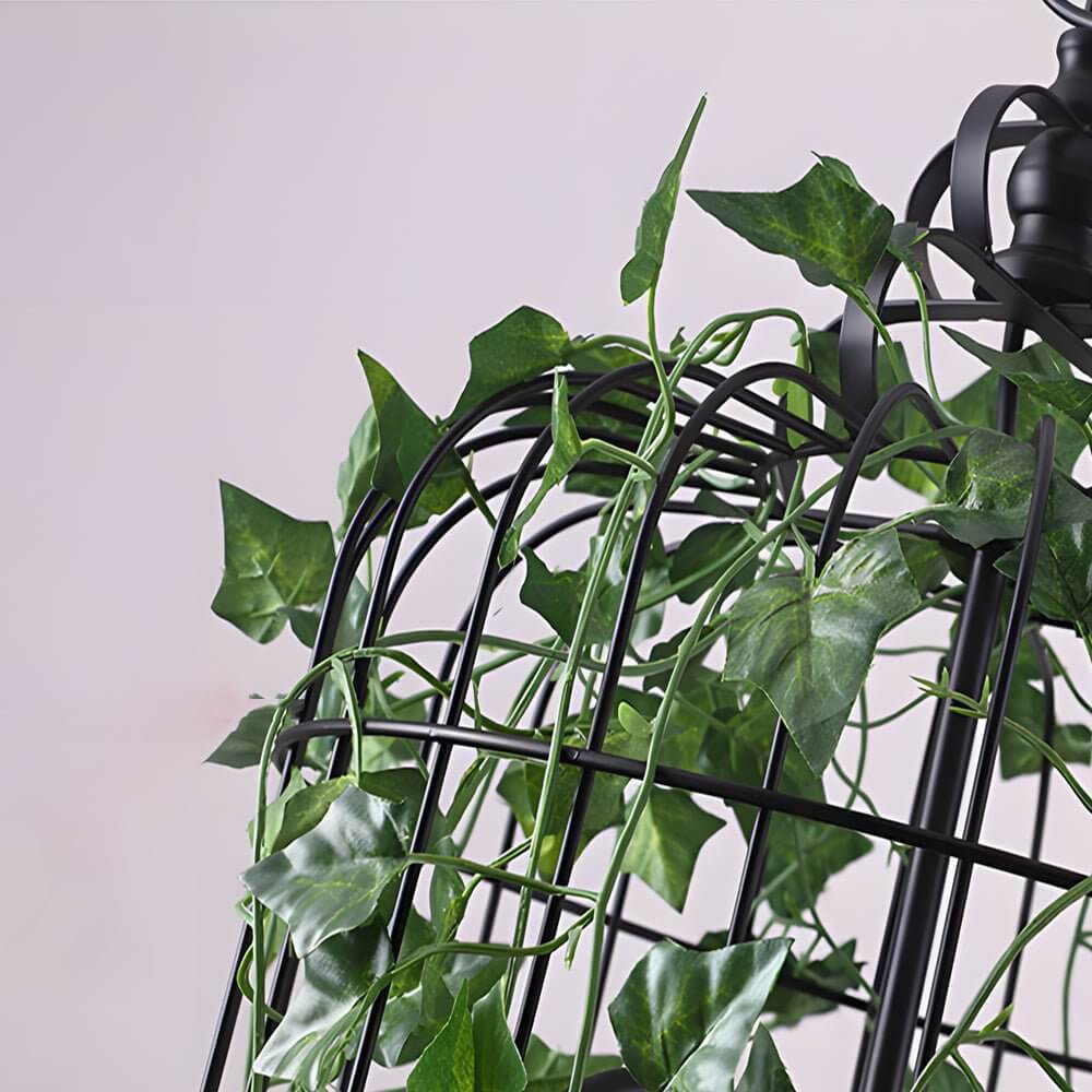 iron cage pendant light inspired by the enchanted forest adorned with vines