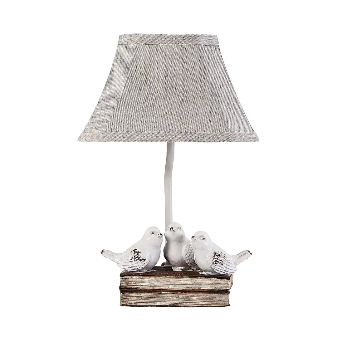 Fabric Light Table Lamp Featuring a Small Bird Perched on Stacked Books Luxe