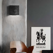 led wall light with frosted cement eclipse design