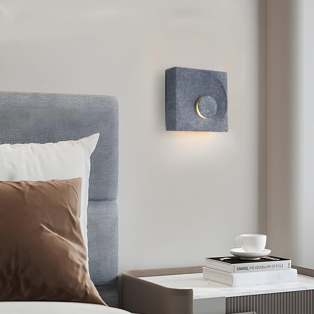 led wall light with frosted cement eclipse design