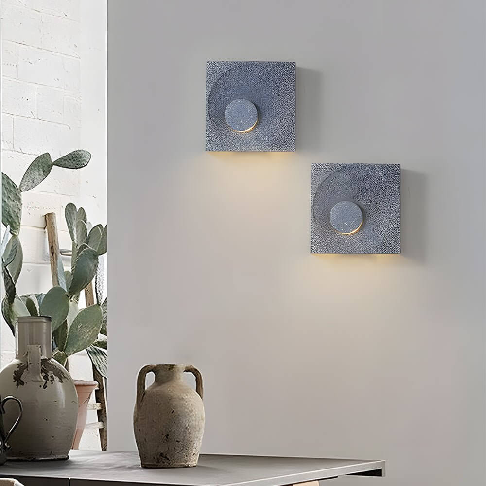 led wall light with frosted cement eclipse design