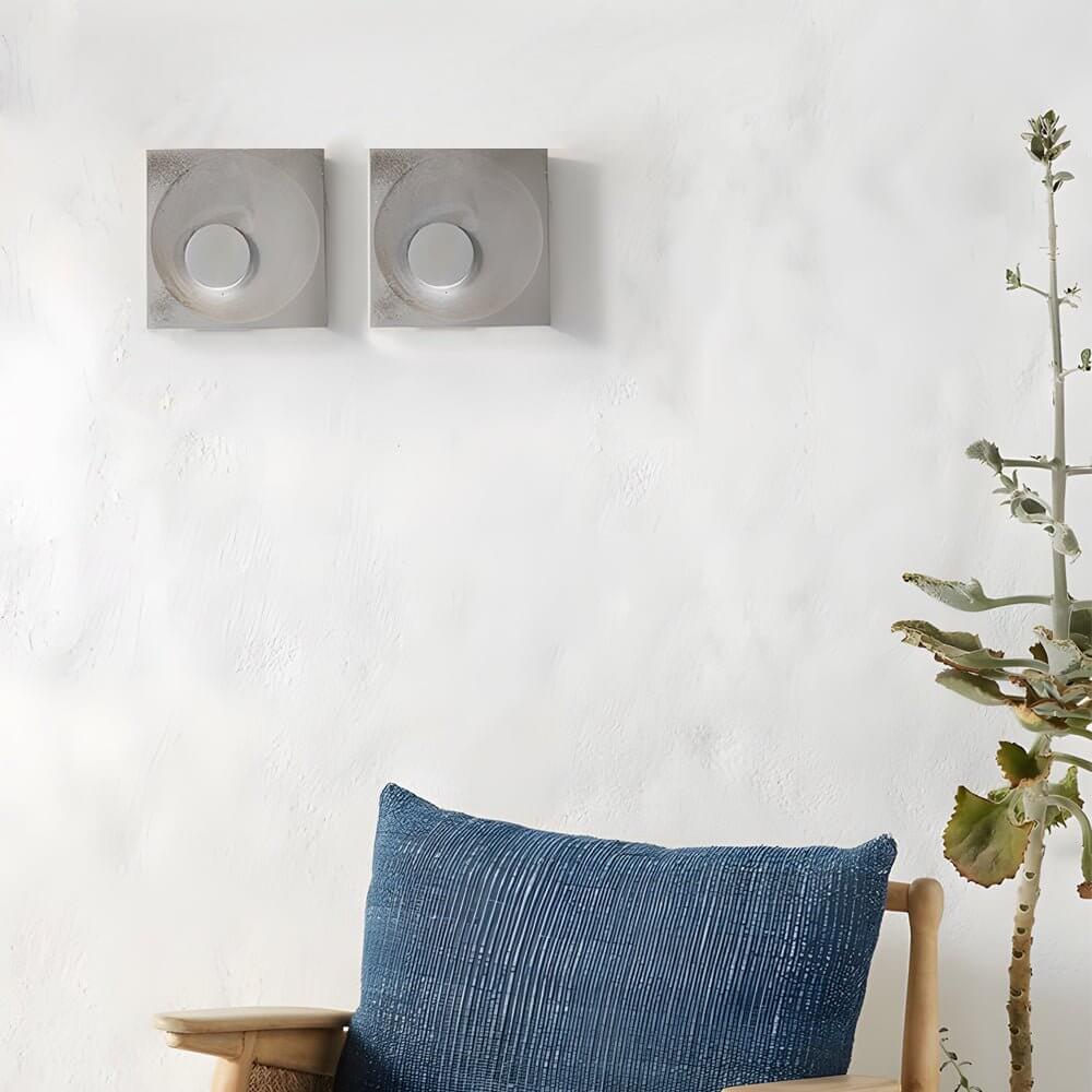 led wall light with frosted cement eclipse design