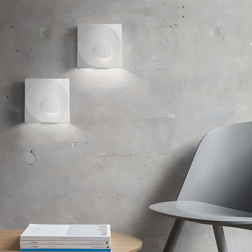 led wall light with frosted cement eclipse design