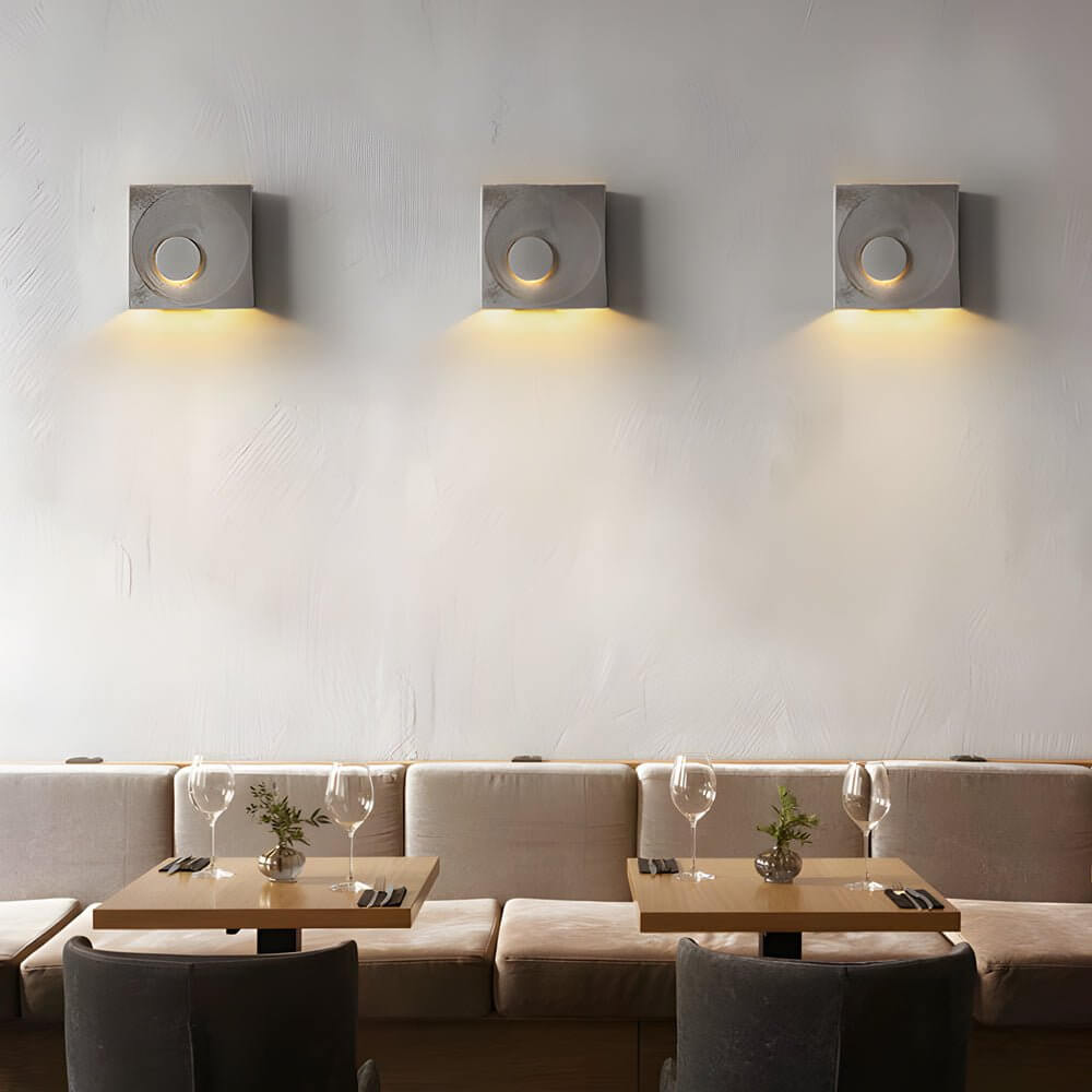 led wall light with frosted cement eclipse design