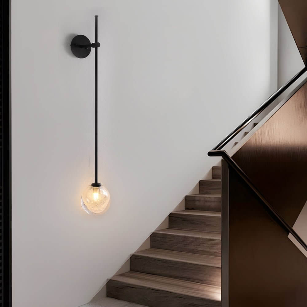 slim wall light with a single glass bubble globe