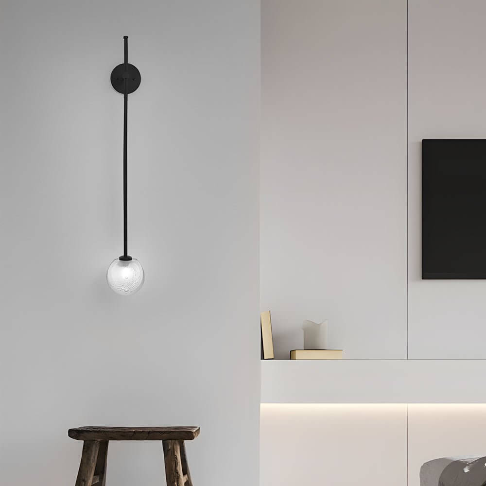 slim wall light with a single glass bubble globe