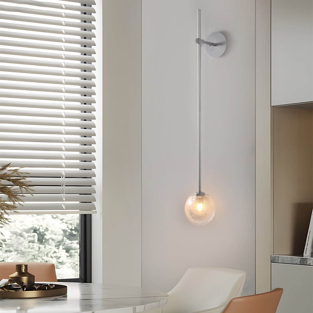 slim wall light with a single glass bubble globe